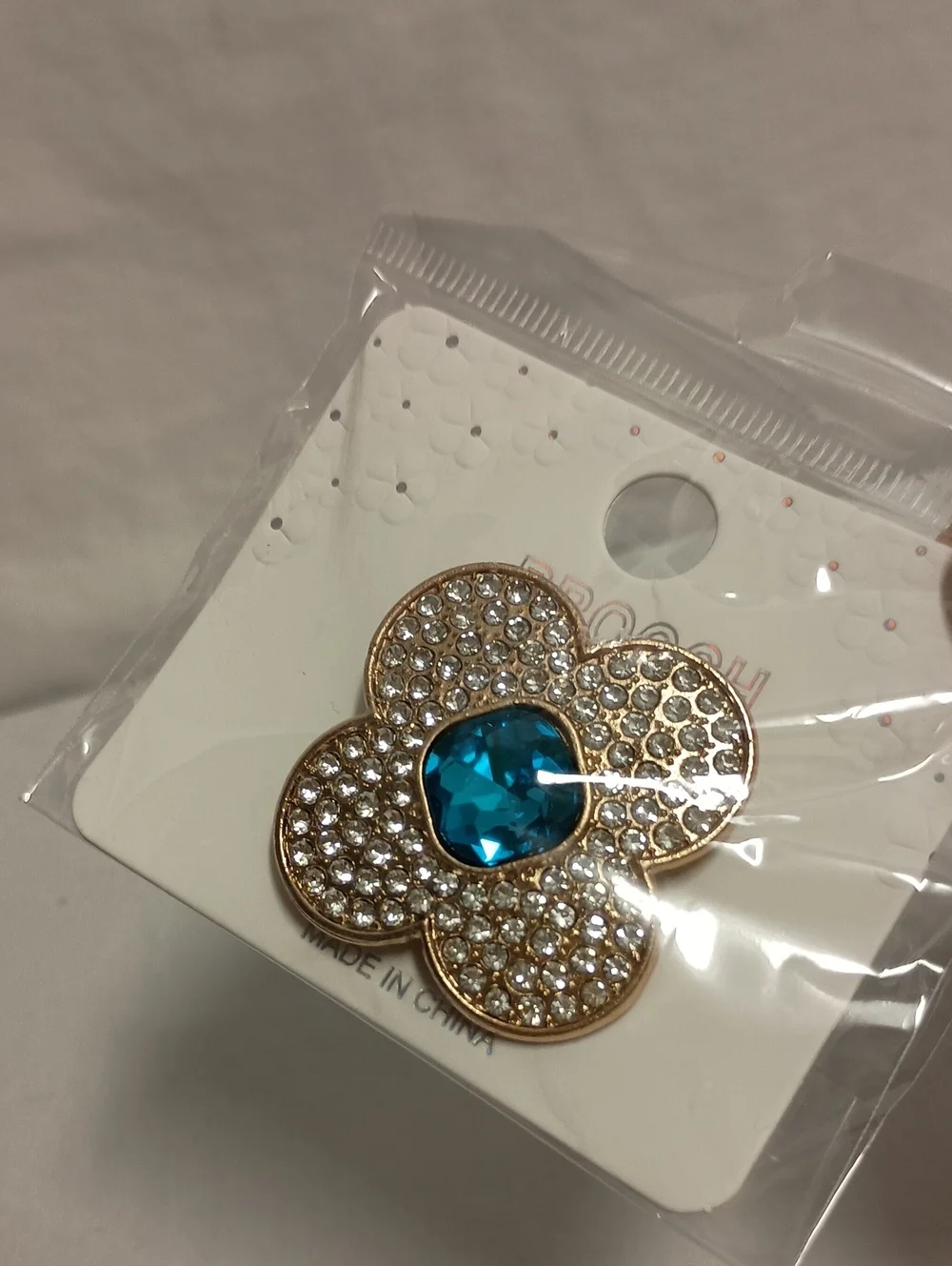 Gold Tone Rhinestone Flower Brooch Pin with Iridescent Crystal Center Blue